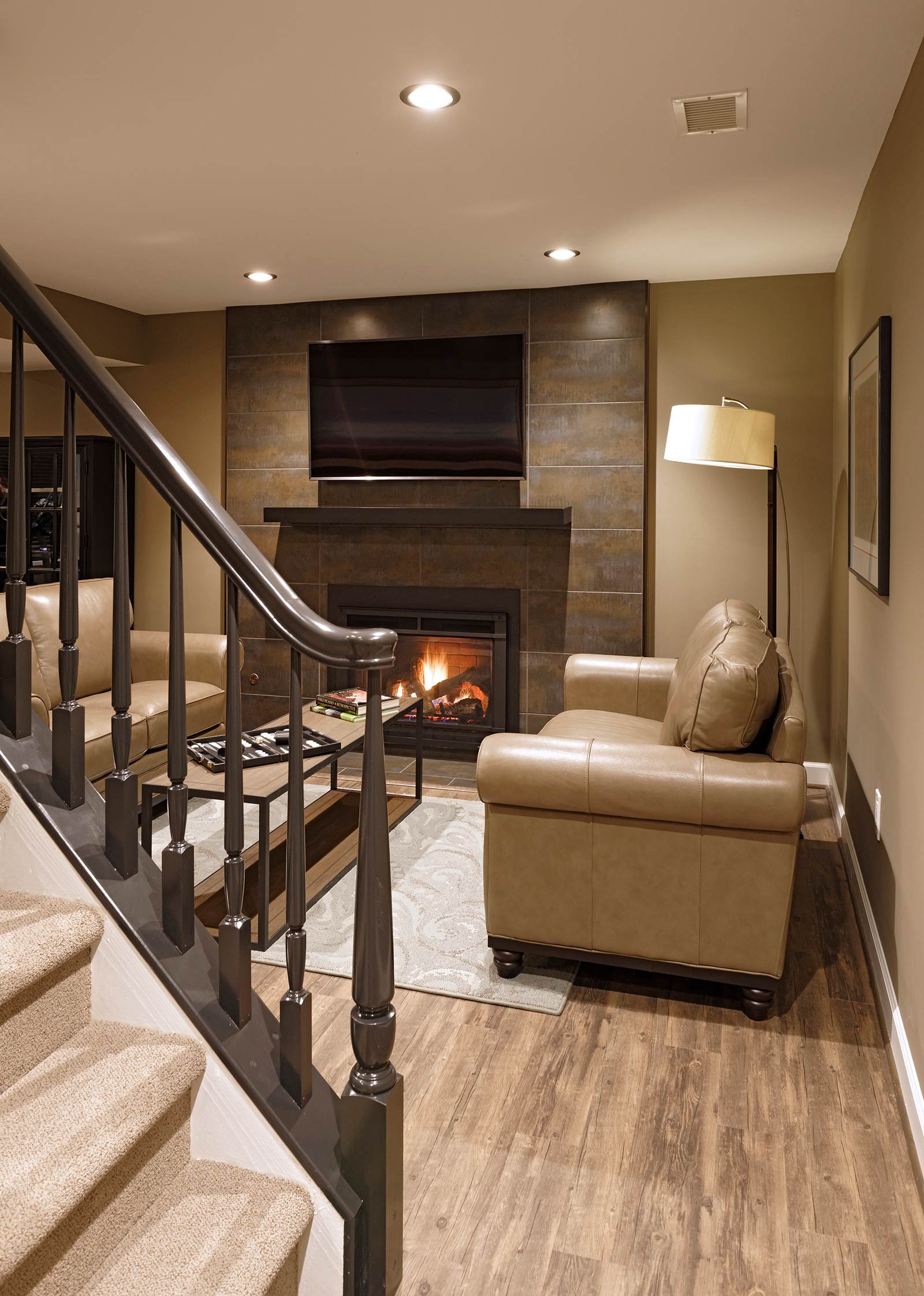 Basement with wellness design in mind with gas fireplace