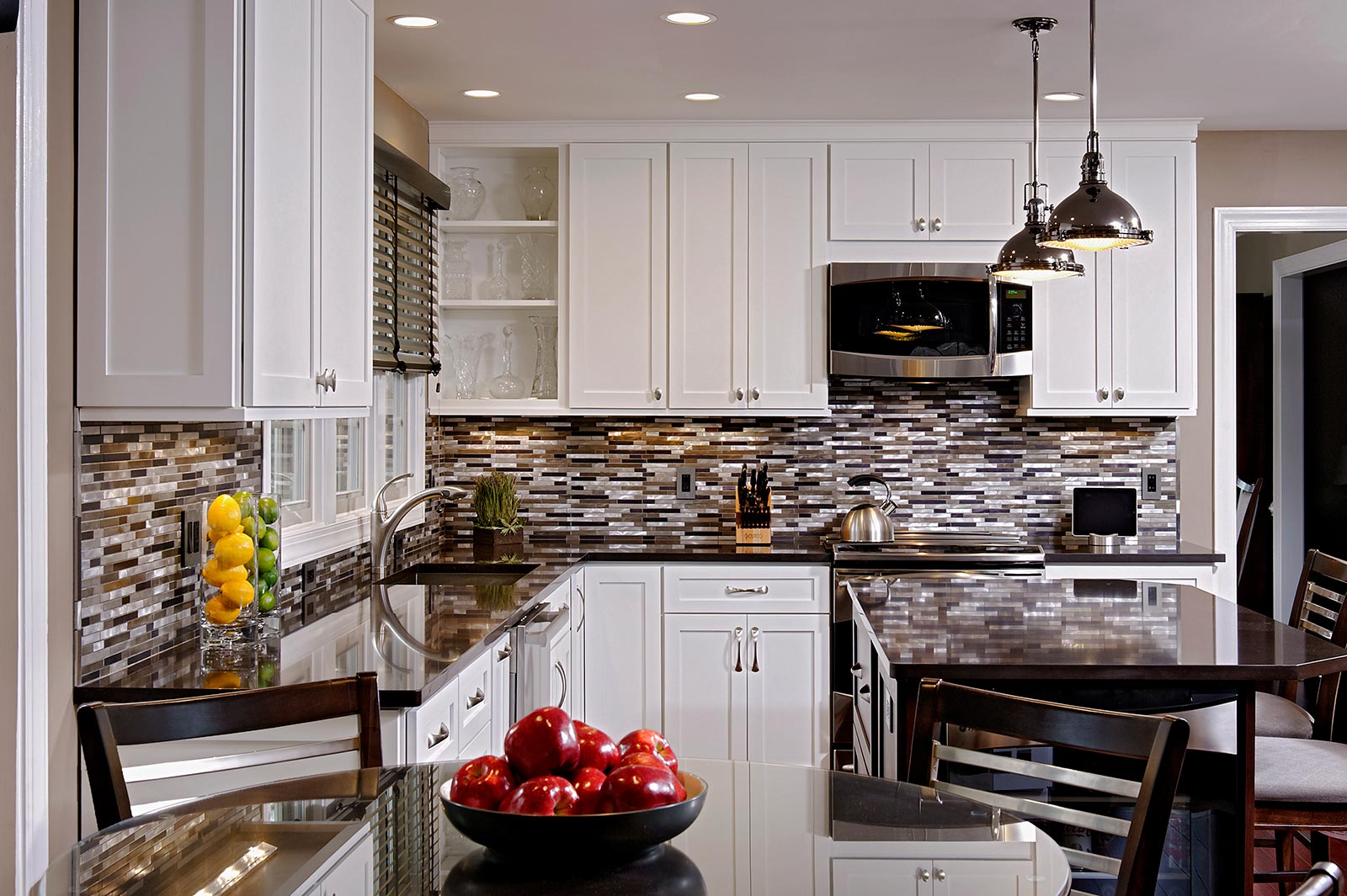White Kitchen with black countertops and modern metallic backsplash